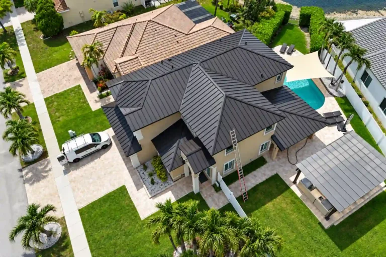 Aerial view of a new dark metal roof on a two story pool home
