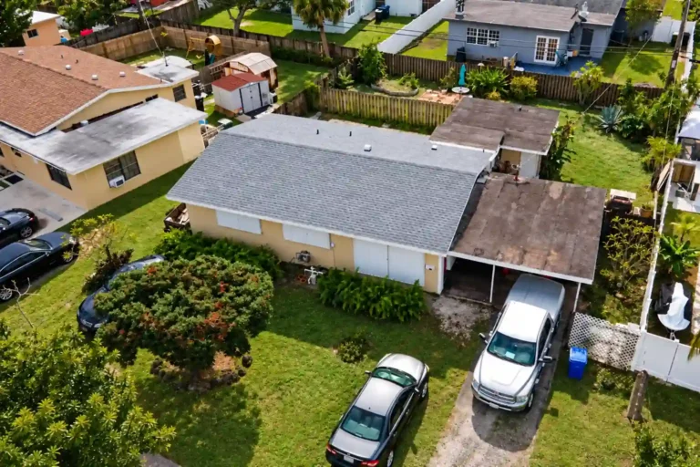 Light gray roof on a single story home with a carport